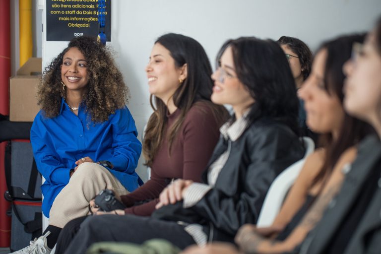 A row of women smiling and engaged during a talk, leaving with language and clarity rather than a week of inspiration