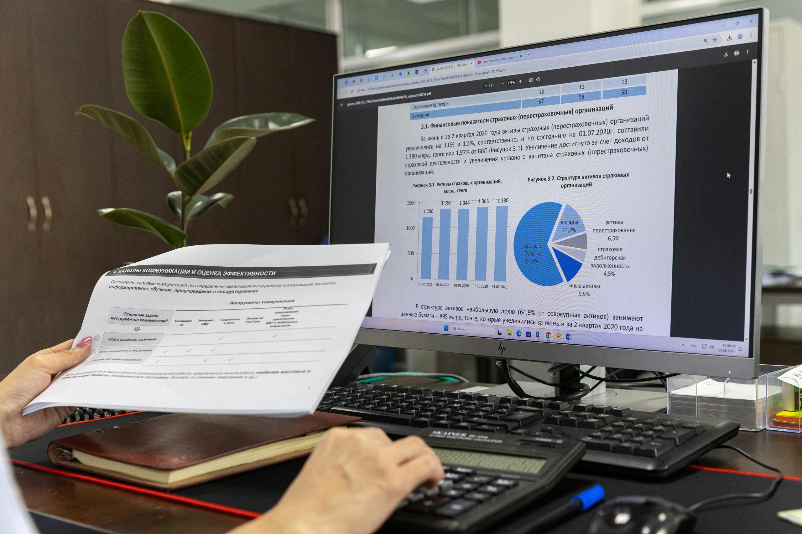 Person working at a desk with a monitor of charts and reports, building digital systems that turn care into action