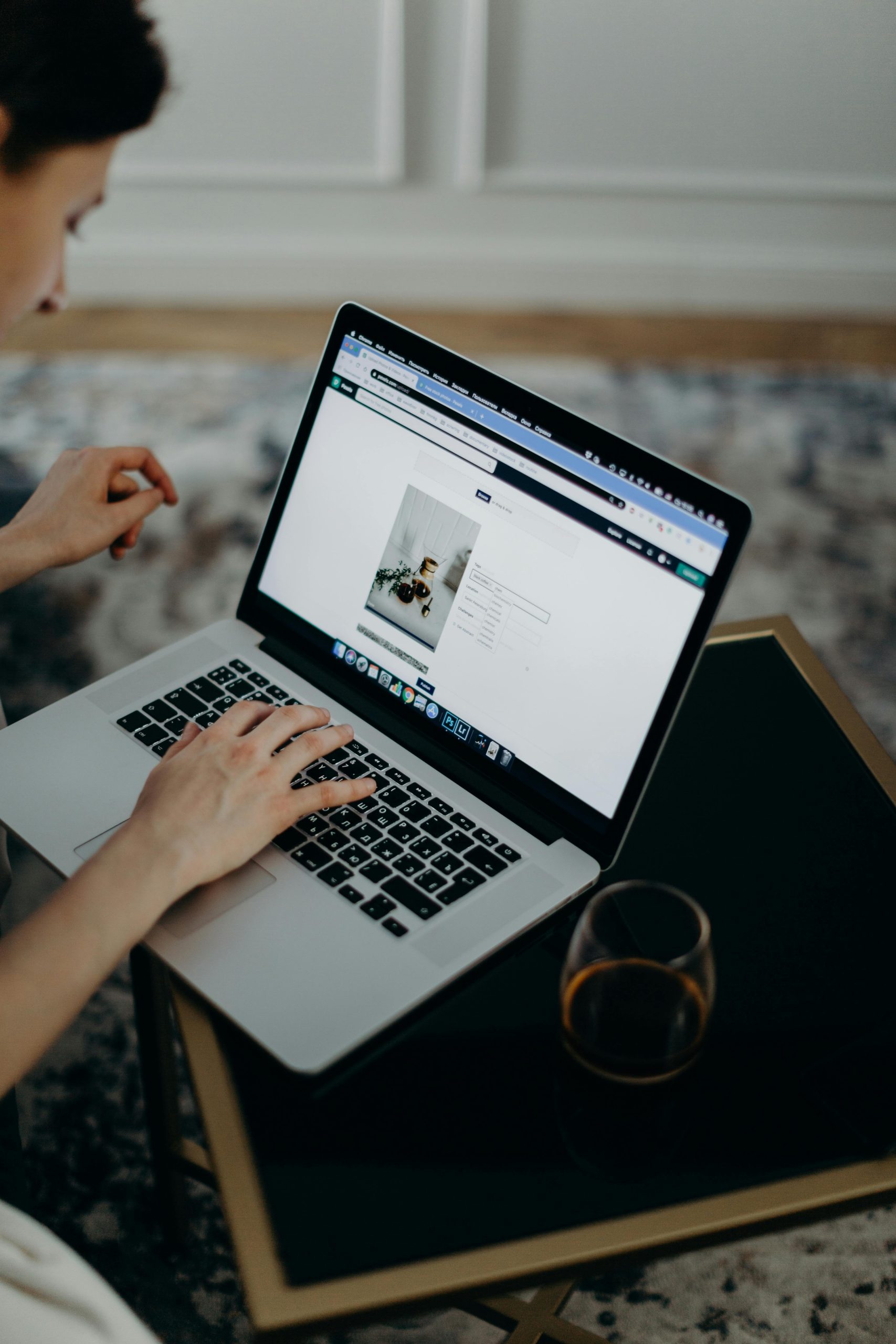 Hands typing on a laptop showing a website built to feel good and convert visitors