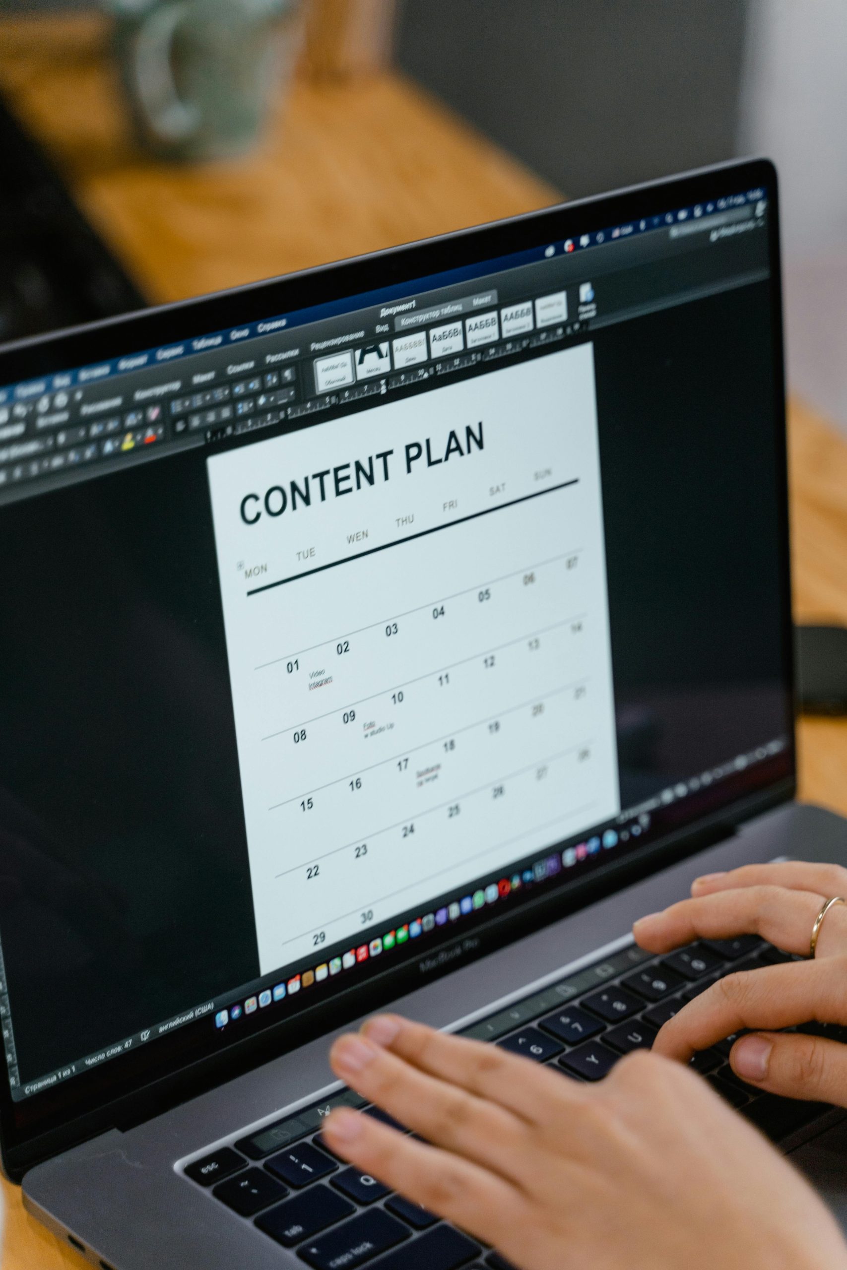 Laptop displaying a monthly content plan calendar that keeps publishing on strategy